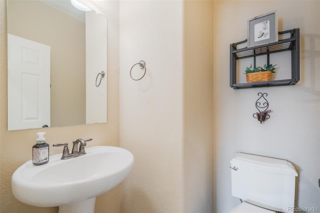 bathroom with toilet and sink