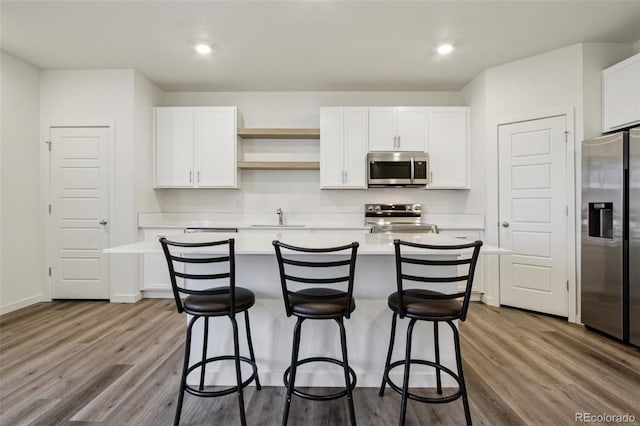 503 S Rollie Ave Unit 13C, Fort Lupton, CO 80621 - kitchen featuring stainless steel appliances, light countertops, white cabinets, open shelves, and recessed lighting