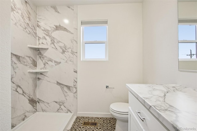 503 S Rollie Ave Unit 13C, Fort Lupton, CO 80621 - bathroom featuring plenty of natural light, vanity, a marble finish shower, and tile patterned floors