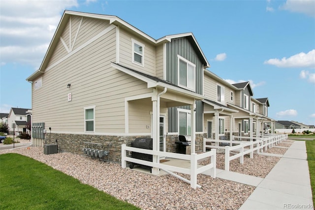 503 S Rollie Ave Unit 13C, Fort Lupton, CO 80621 - view of side of home with a residential view, stone siding, and board and batten siding