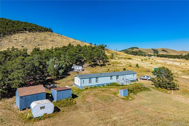 birds eye view of property featuring a mountain view