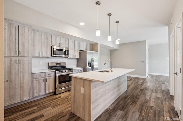 290 S Cherrywood Dr Unit 202, Lafayette, CO 80026 - kitchen featuring appliances with stainless steel finishes, dark wood-type flooring, backsplash, an island with sink, and recessed lighting