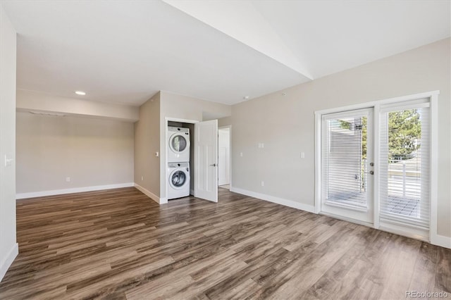 290 S Cherrywood Dr Unit 202, Lafayette, CO 80026 - unfurnished living room with stacked washer / dryer, wood finished floors, lofted ceiling, and recessed lighting