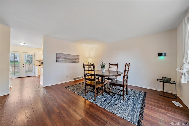 dining area with wood finished floors, baseboards, and french doors