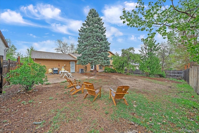 fenced backyard with a fire pit
