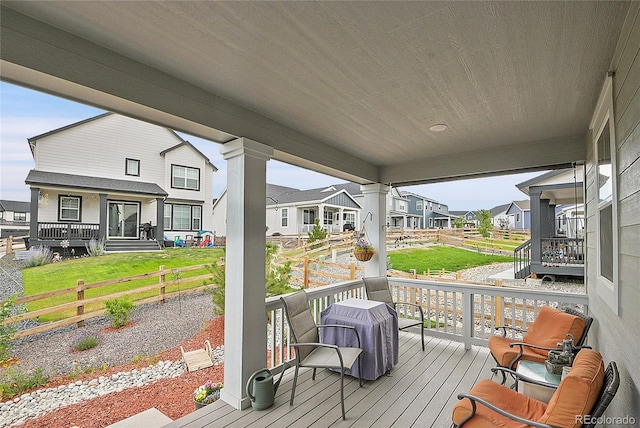 deck with covered porch and a lawn