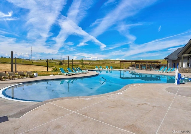 view of swimming pool with a patio area