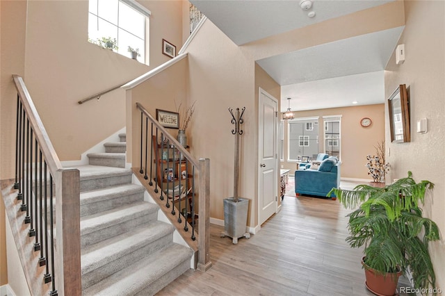 stairs featuring wood-type flooring