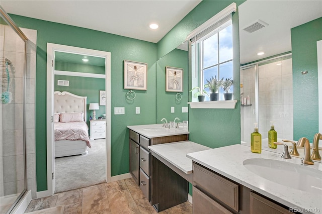 bathroom featuring vanity and a shower with shower door