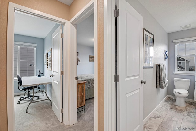 bathroom featuring toilet and a textured ceiling