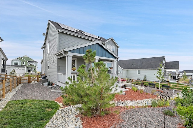 exterior space with a porch and solar panels