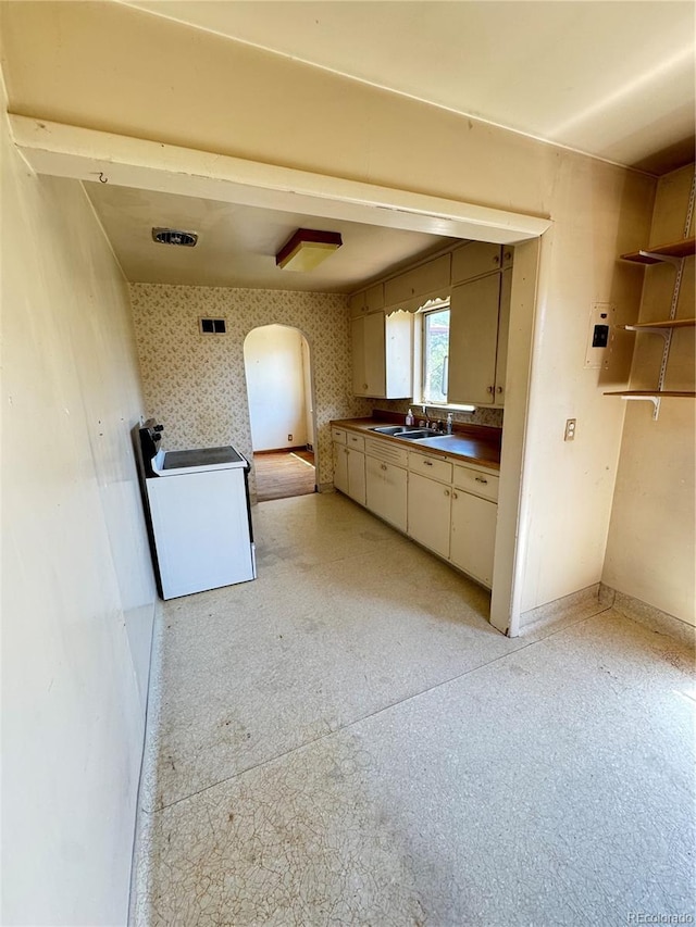 460 Yates St, Denver, CO 80204 - kitchen featuring arched walkways, range, and dark countertops