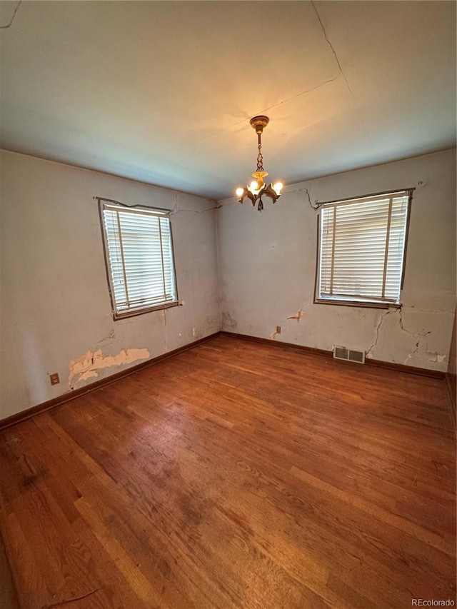 460 Yates St, Denver, CO 80204 - spare room with a chandelier and wood finished floors