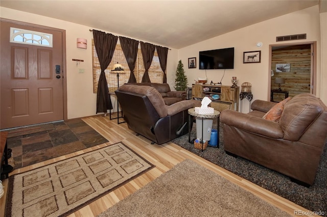 living room with wood-type flooring and vaulted ceiling