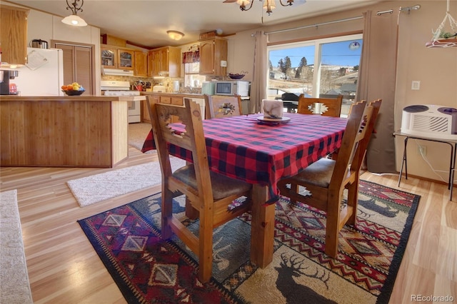 dining space featuring a chandelier and light hardwood / wood-style flooring