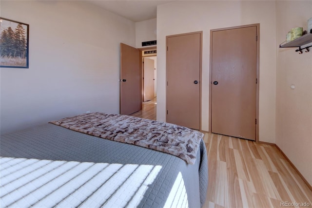 bedroom with light wood-type flooring and a closet