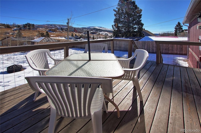 snow covered deck featuring a mountain view