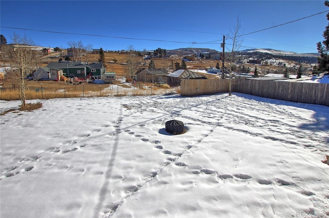 snowy yard with a mountain view