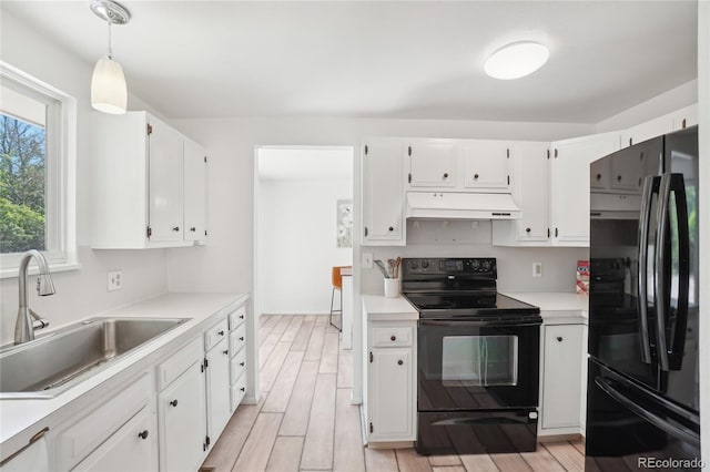 kitchen with black appliances, extractor fan, a sink, white cabinets, and light countertops