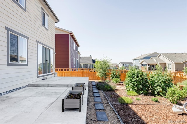 6117 Easton Cir, Frederick, CO 80504 - fenced backyard with a patio, a residential view, and a garden