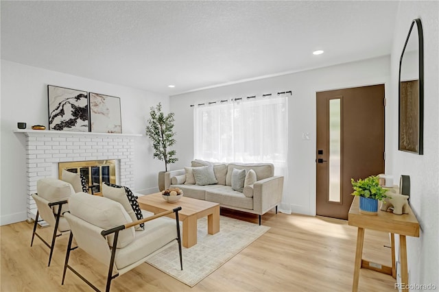 3055 S Winona Ct, Denver, CO 80236 - living room featuring light wood-style flooring, a brick fireplace, and recessed lighting