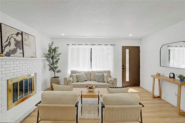 3055 S Winona Ct, Denver, CO 80236 - living area featuring light wood finished floors, recessed lighting, and a brick fireplace