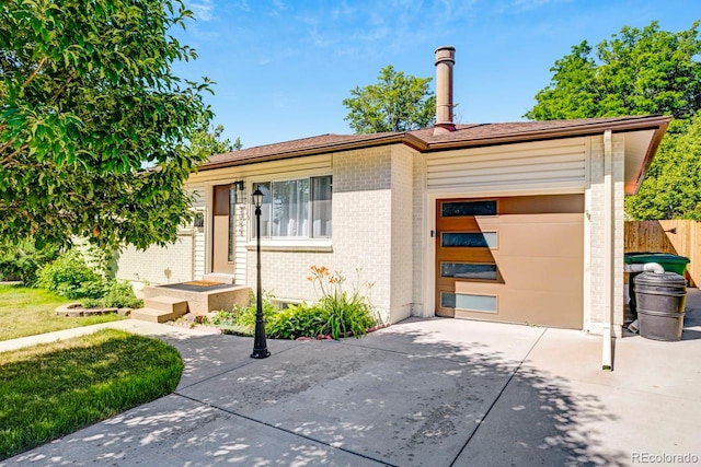 3055 S Winona Ct, Denver, CO 80236 - ranch-style home featuring concrete driveway, brick siding, and an attached garage
