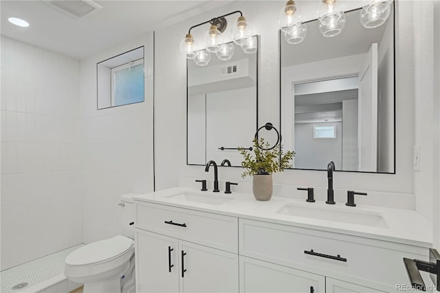3055 S Winona Ct, Denver, CO 80236 - bathroom featuring double vanity and a tile shower