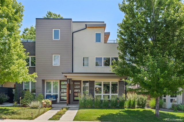 2730 Hooker St, Denver, CO 80211 - contemporary home featuring a front lawn, stucco siding, and brick siding