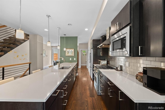 2730 Hooker St, Denver, CO 80211 - kitchen featuring stainless steel appliances, dark wood-type flooring, light countertops, a large island, and recessed lighting