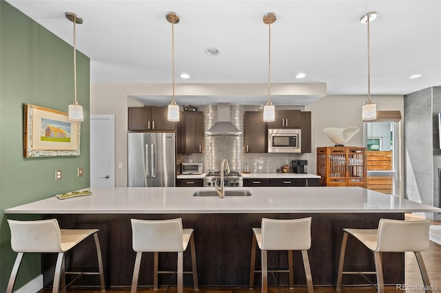 2730 Hooker St, Denver, CO 80211 - kitchen with appliances with stainless steel finishes, wall chimney range hood, light countertops, and backsplash