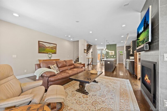 2730 Hooker St, Denver, CO 80211 - living area featuring dark wood-type flooring, stairs, a large fireplace, and recessed lighting