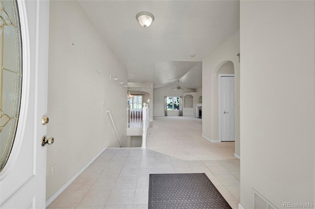 tiled entrance foyer with vaulted ceiling and ceiling fan