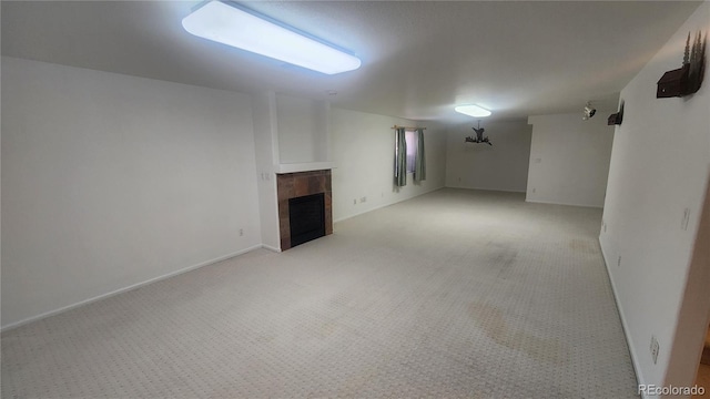 basement with light colored carpet and a tiled fireplace