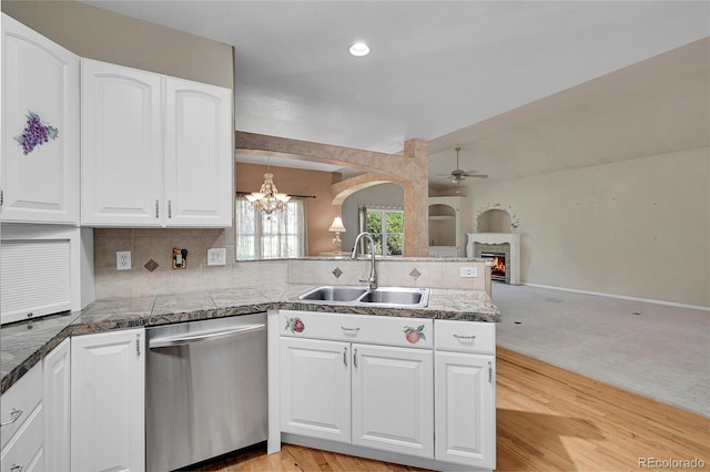 kitchen featuring white cabinetry, sink, light carpet, and dishwasher