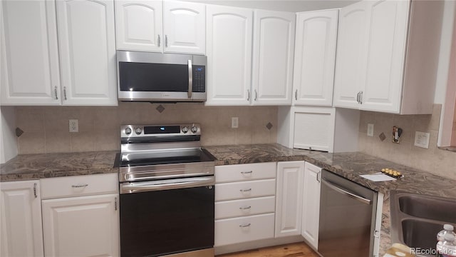 kitchen with stainless steel appliances and white cabinets