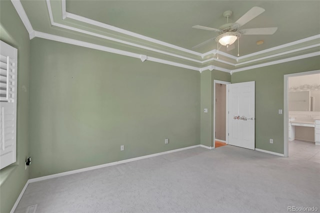 unfurnished bedroom with light carpet, crown molding, a raised ceiling, and ceiling fan