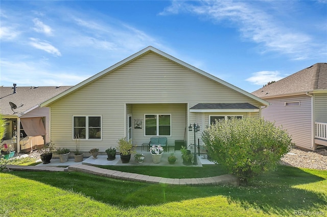 back of house featuring a patio area and a lawn