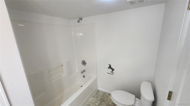 bathroom with shower / bath combination and toilet