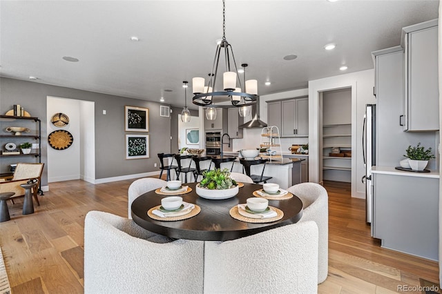 16554 W 93rd Way, Arvada, CO 80007 - dining room with a chandelier, recessed lighting, and light wood-type flooring