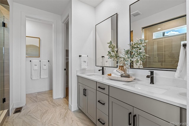 16554 W 93rd Way, Arvada, CO 80007 - full bathroom featuring double vanity, a shower stall, and marble finish floors