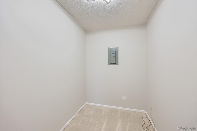 carpeted empty room with a textured ceiling