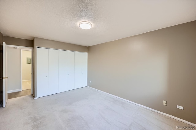 unfurnished bedroom with a closet and a textured ceiling