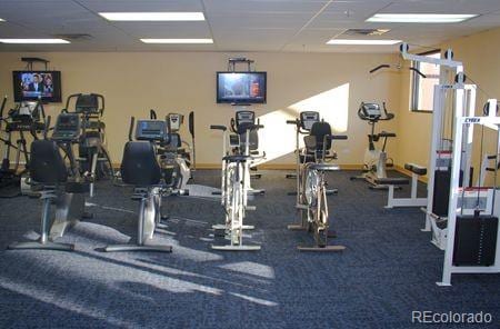 exercise room with a paneled ceiling