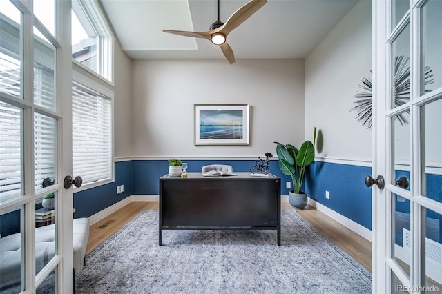office space with french doors, wood finished floors, baseboards, and ceiling fan