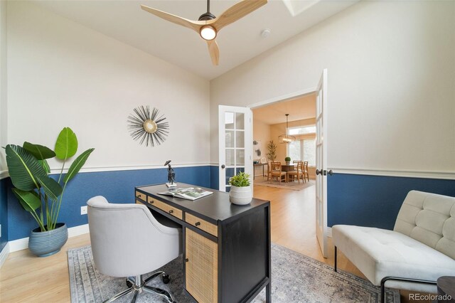 home office featuring wood finished floors, a ceiling fan, and baseboards
