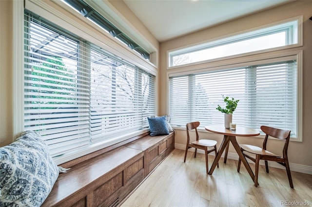 living area featuring light wood finished floors and baseboards