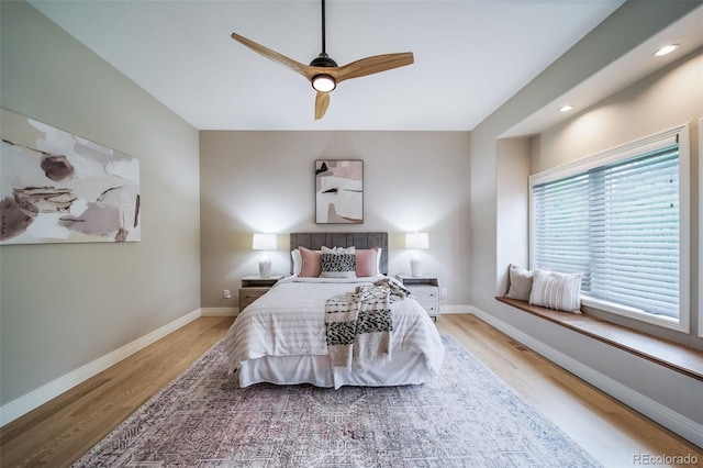 bedroom with light wood-style floors, baseboards, ceiling fan, and recessed lighting