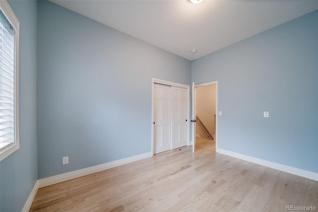 empty room featuring light wood-style flooring and baseboards