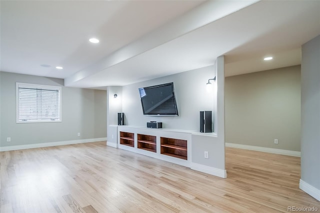 unfurnished living room featuring light wood-type flooring, baseboards, and recessed lighting